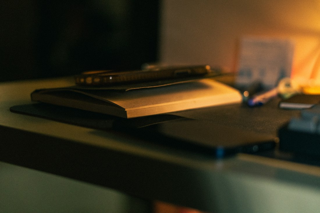 Notebook on a desk in warm lamp light